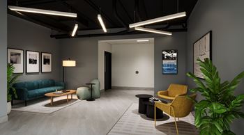 A modern living room with a blue couch, a yellow armchair, and a coffee table.